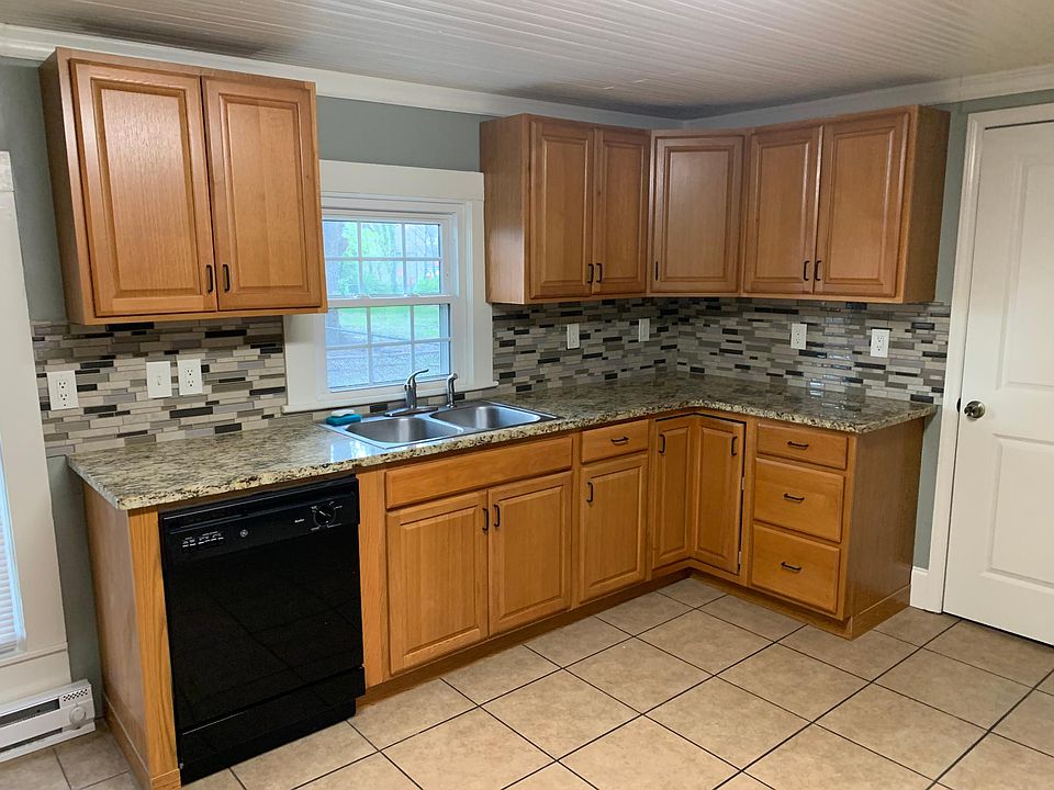 Kitchen with granite countertops and tile backsplash