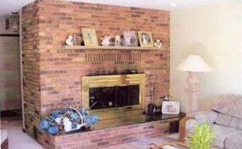 Living room enhanced by brick (wood burning) fireplace.Newer carpeting, bow window (with custom-made