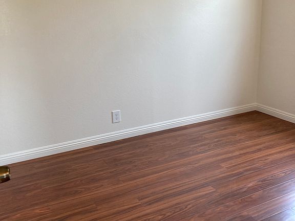 first bedroom with newly laminated flooring