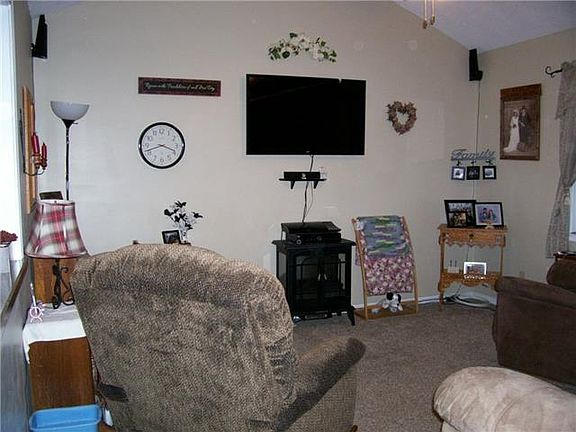 Living room has open window/bar to kitchen