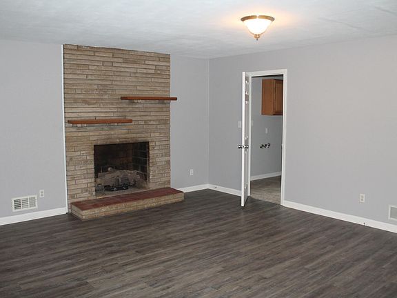 Large Den with fireplace - door leads to large utility room and garage