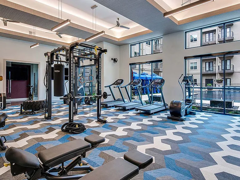 Griffis Frisco fitness center with cardio machines and weight equipment.