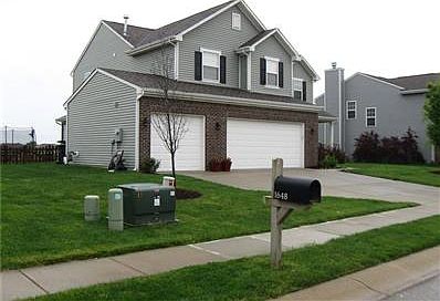 The lush, green lawn has been well-cared for and professionally fertilized each month.