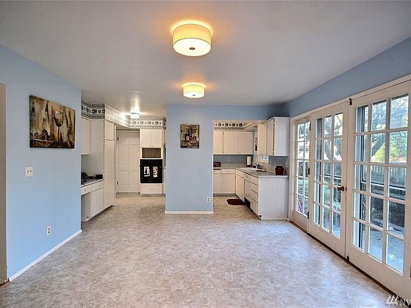 Now this is a dining room!  How much room do you need?  There is approximately 12 feet of windows that look to the rear yard and patio, essentially bringing the outdoors in!  This room offers new lighting to boot!