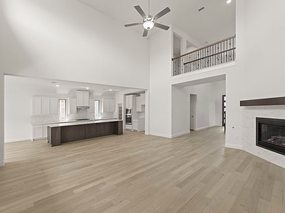 REPRESENTATIVE PHOTO - Spacious open-concept living area in the Edgewood floor plan featuring vaulte