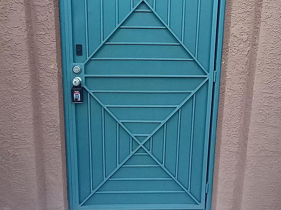 Private entrance with security gate and dual locks.