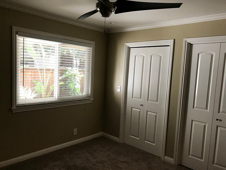 Master bedroom with walk-in closet organizers and lighting in closet