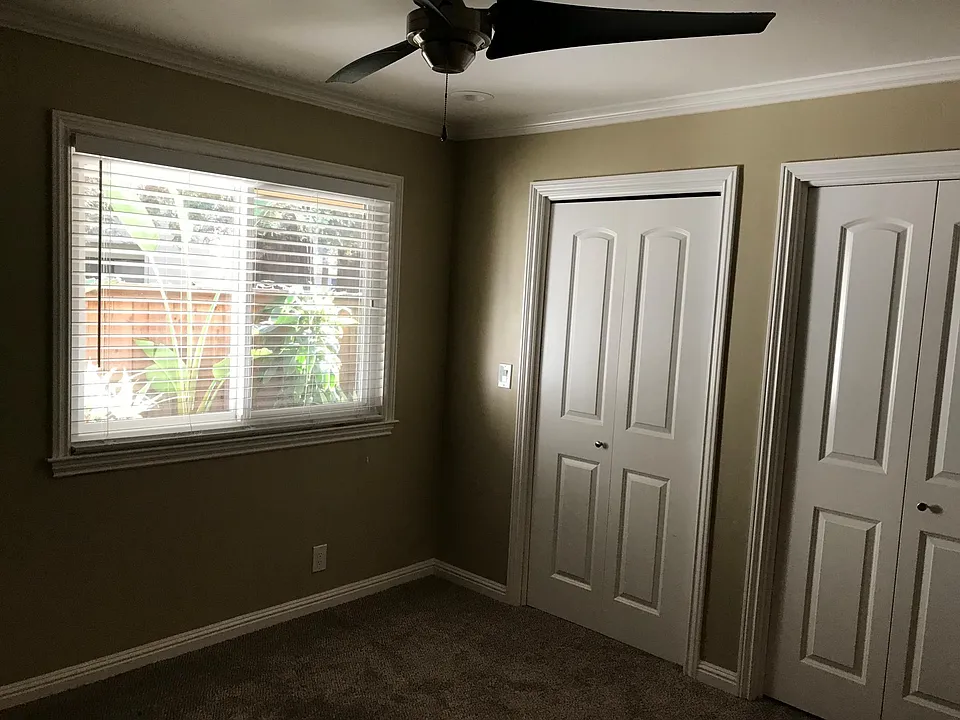 Master bedroom with walk-in closet organizers and lighting in closet