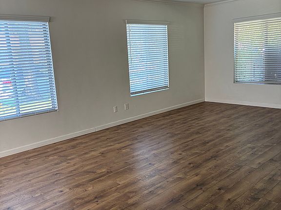 Large living room with views to front lawn and mountains.