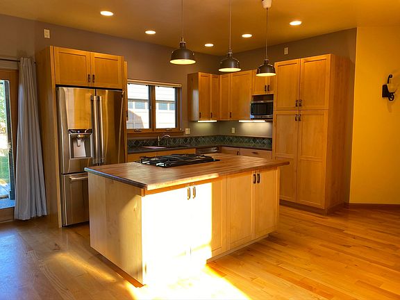 Kitchen with gas stovetop, large fridge, and tons of storage