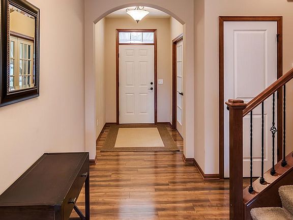 The entry hallway has a coat closet nearby for storage.