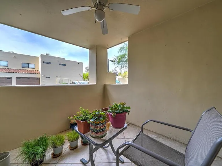 Private covered patio with tile and new ceiling fan in July 2026 (old fan in picture).