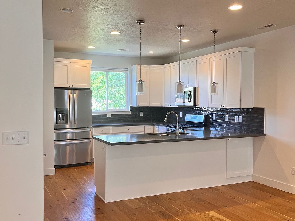Large kitchen with quartz counters and white cabinets