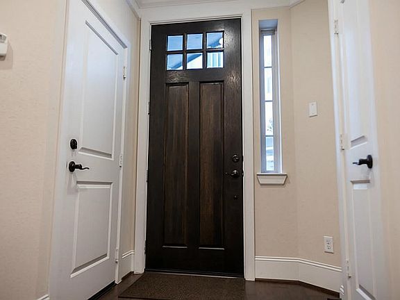 Beautiful entry with access to the garage, the storage closet and large utility room.