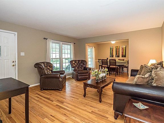 A view from the Entry toward the front elevation of the Living Room.  The large Double Window and the Dining Room Window overlook the front  veranda.   Notice the leaded glass insert that completes the Main Entry Door System.