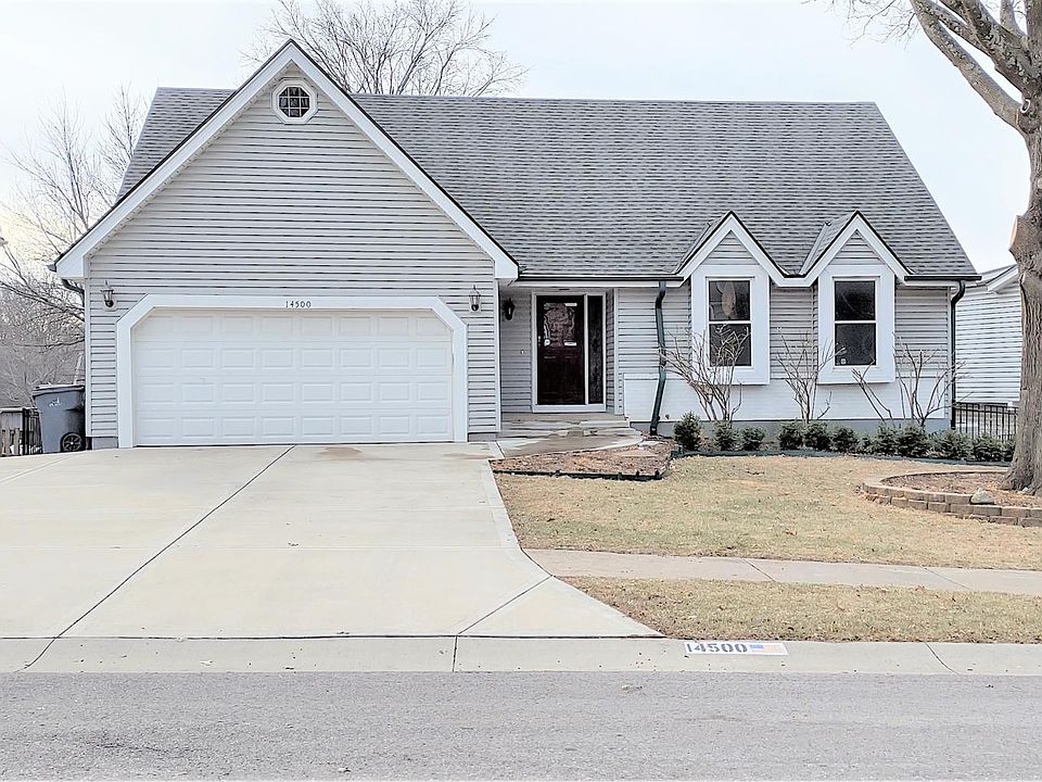 Ranch style with wide driveway with extra parking pad.