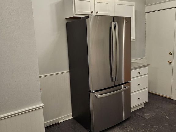 Other side of the kitchen with brand new refrigerator