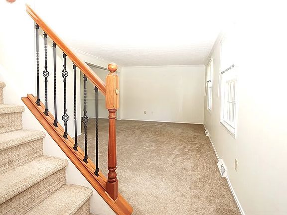 Entryway leading to living room/dining room area, with access to eat-in kitchen (to the left)
