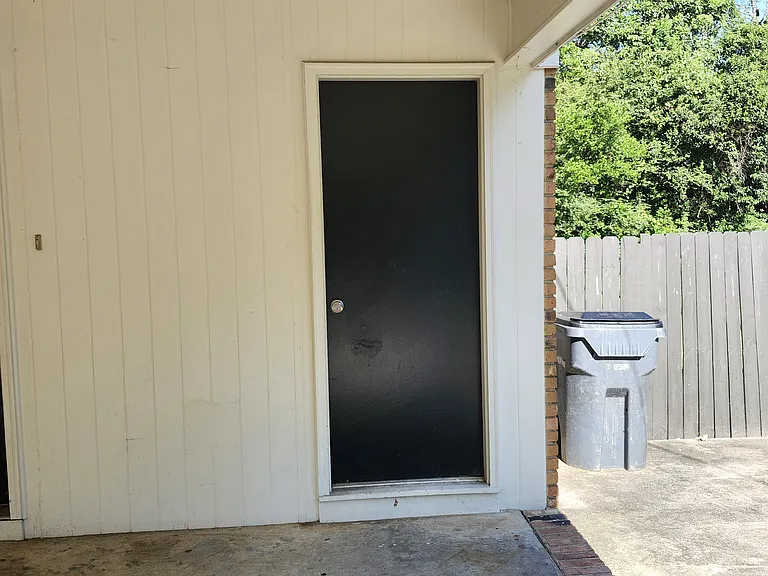 Storage Area-Located next to carport.Trashcan located on the paved area near fence.