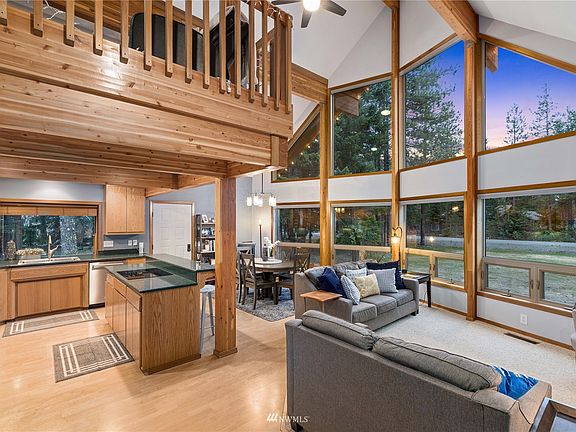 Classic chalet architecture with exposed beams, large picture windows and open concept design.