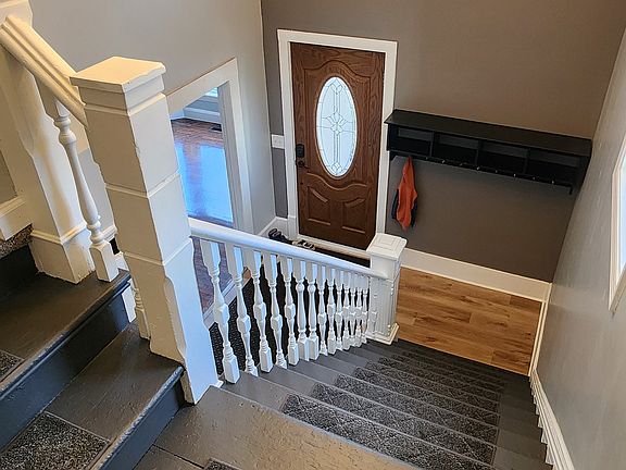 Grand two story entry with new flooring and chandelier