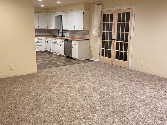 Living room view into kitchen and sun room
