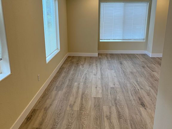 View of Living room from kitchen. Home has new laminate flooring and white millwork throughout.