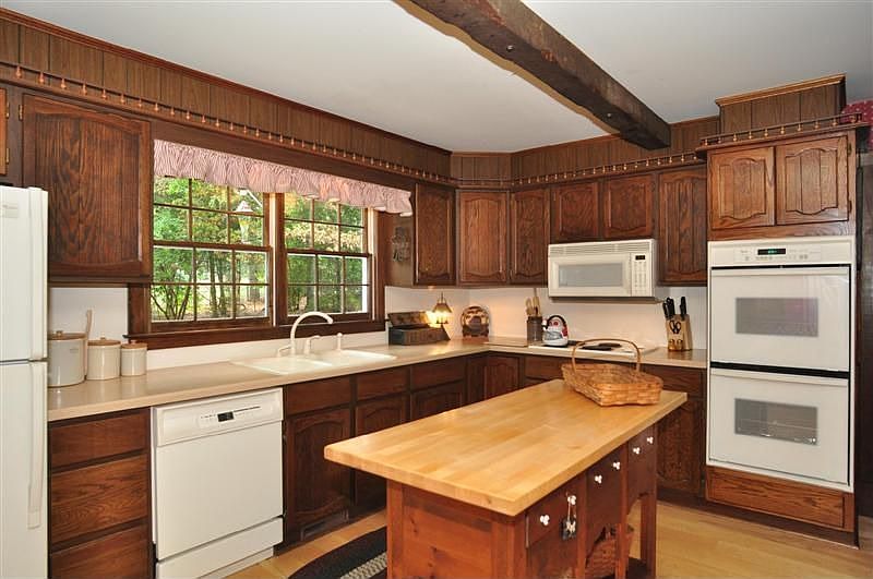 Kitchen island with butcher block top, double ovens, built-in microwave