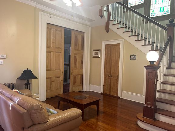 Library, front interior wood steps, stain glassed windows, 1/2 bath below steps