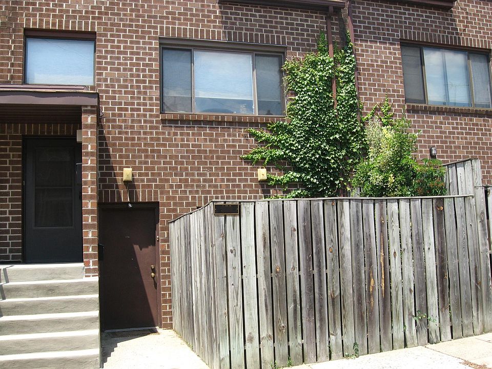 Front door is at ground level between neighbors stairs on the left and our fenced courtyard on the right.
