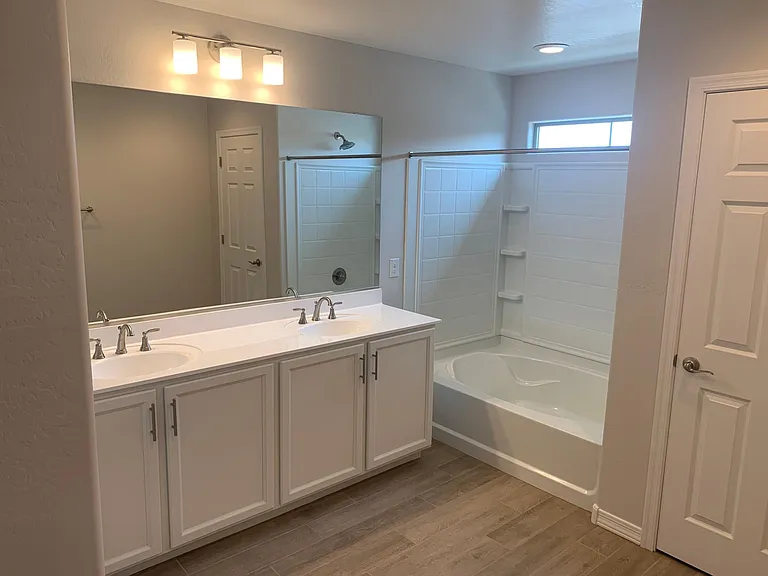 Master Bathroom With Dual Vanity and Tub/Shower Combo . Also a Large Linen Closet