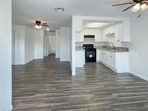 Open floor plan with laminate wood floors throughout and upgraded kitchen.