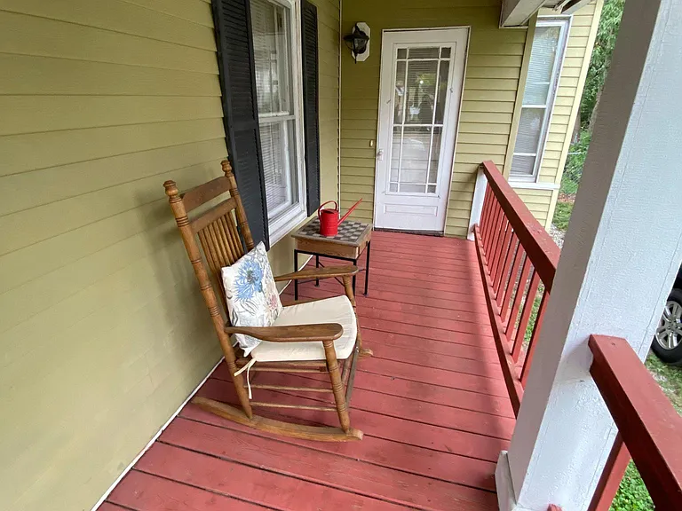 The side covered porch with a lighted private entrance to the bedroom with the attached bathroom.
