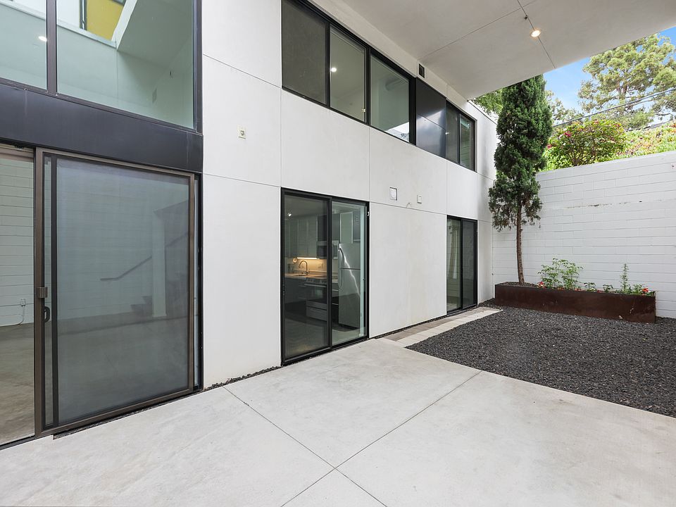 Private Courtyard - Fully Enclosed and Fenced, featuring a garden with planted vegetables and herbs.