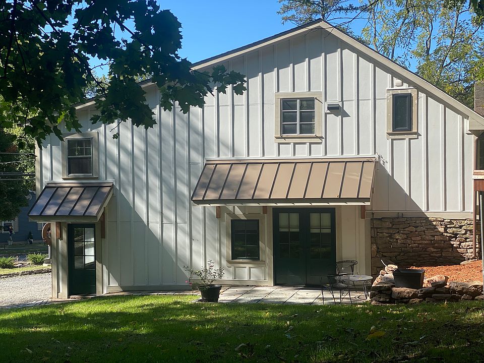 Back of carriage barn with cozy terrace for morning coffee, lunch or evening cocktails and upper garden potential.