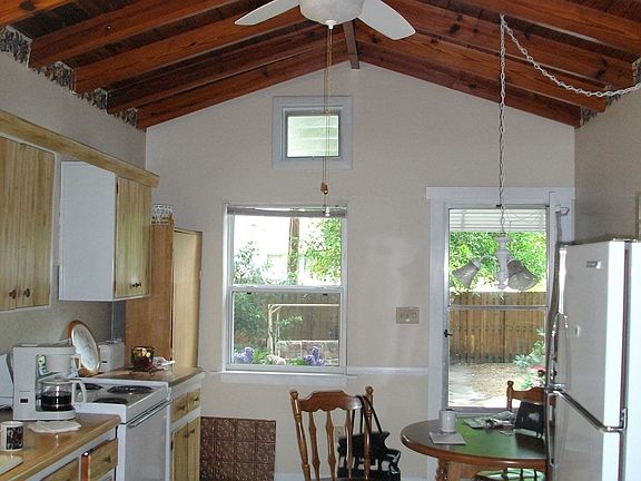 Wood beamed ceiling and ceramic tile floors in the oversized kitchen