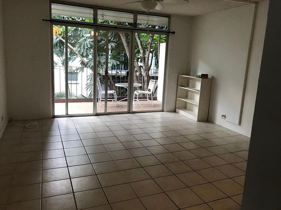 Front door view of living room, kitchen on right