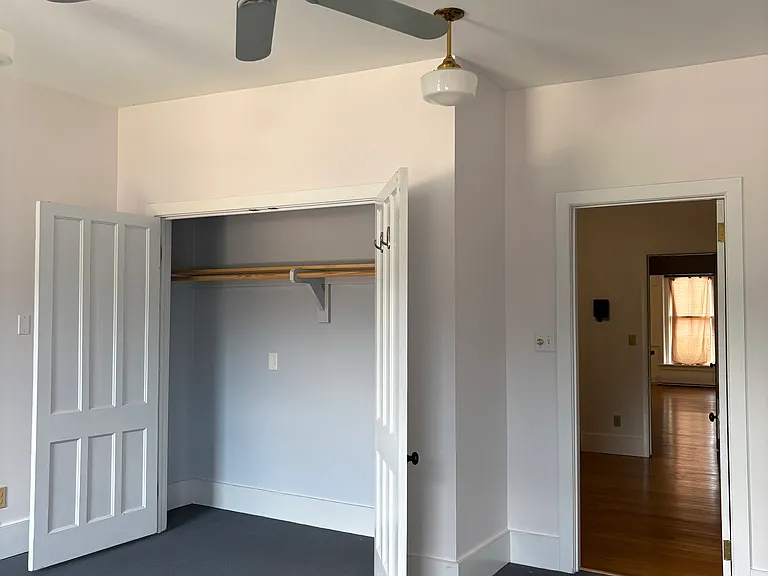 Rear bedroom with large closet looking into work/office/studio space
