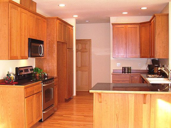 Kitchen includes custom cherry cabinets and SS appliances