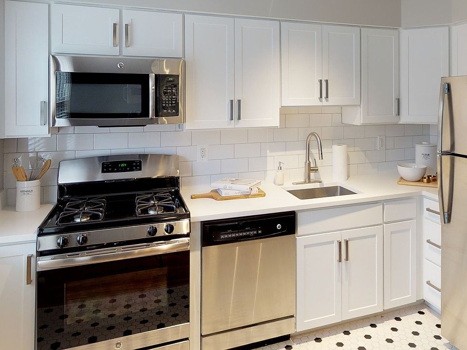 Tiled kitchens with sleek cabinetry