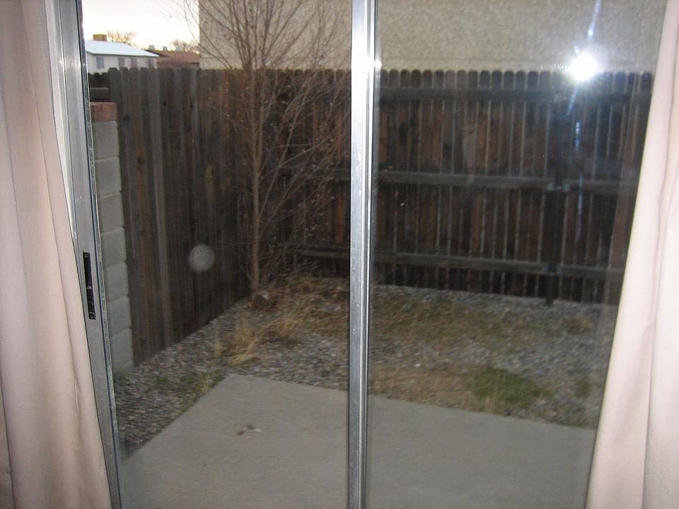 Enclosed patio outside sliding glass doors in kitchen.