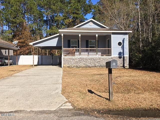 Street view featuring front porch, carport, and fenced backy