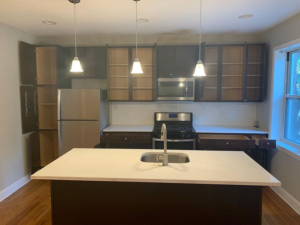 Expansive kitchen with numerous spacious storage cabinets and an oversized island.