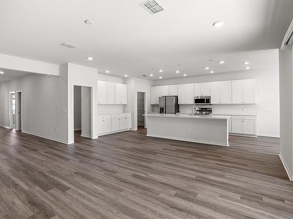 Enjoy a light-filled open living area - Everly by Highland Homes