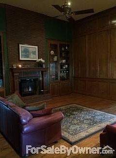 Great Room
						:
						Antique carved mantelpiece around large brick fireplace with wood stove.