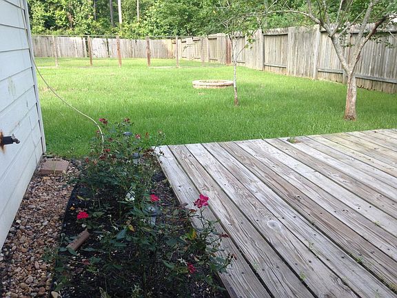 Back deck looking into huge backyard, with yard service included no worries in maintaining it.