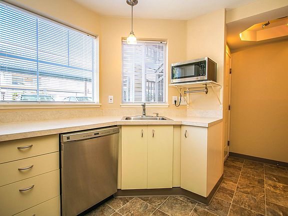 As you walk in to your home, the large kitchen is to your right.