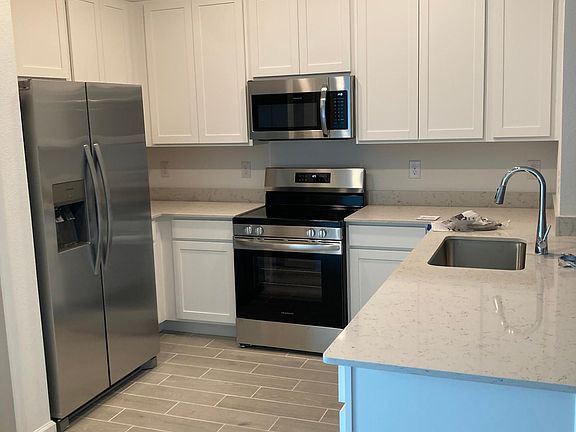 Kitchen with quartz and stainless steal appliances