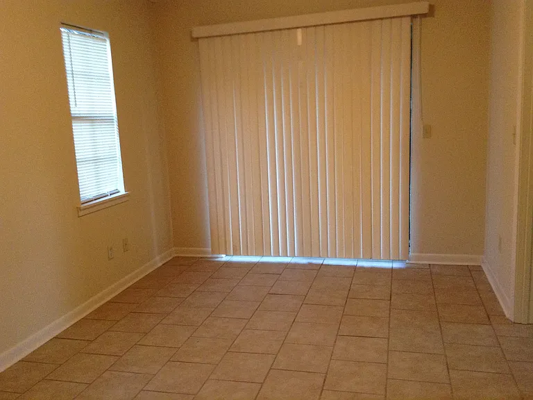Another pic of bedroom, showing sliding glass doors leading to deck or patio.