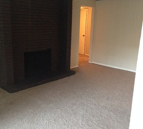 Living room with wood burning fire place